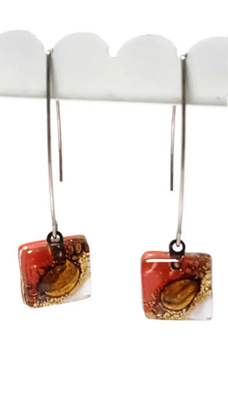 Open oval wire with handmade in red, soft lavender and brown recycled glass beads.